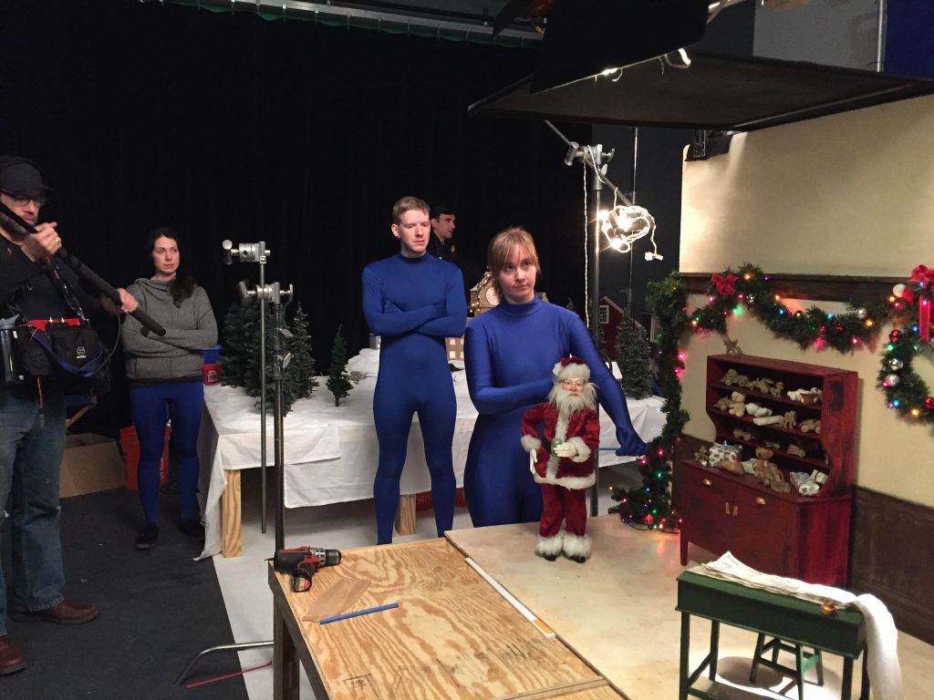 Laura Collard puppeteers Santa, watched by Dylan Rohman and Vanessa Romanoff